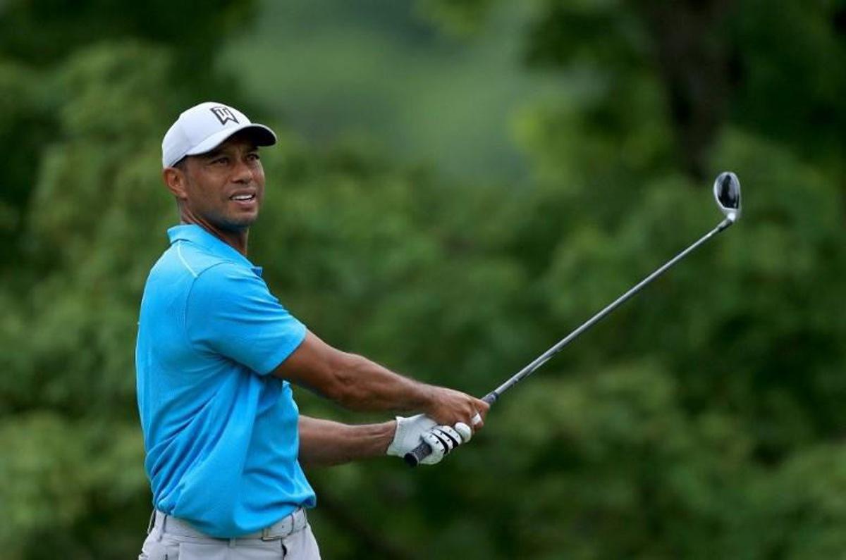(FILES) In this file photo taken on July 16, 2020 Tiger Woods of the US plays his shot from the fifth tee during the first round of The Memorial Tournament in Dublin, Ohio.     Woods said on December 8, 2021, he will make his return to competitive golf at next week's PGA Tour PNC Championship in Florida. The former world number one, who has not played since suffering career-threatening leg injuries in a car crash in Los Angeles in February, will play in the December 16-19 tournament alongside his son Charlie.  Sam GREENWOOD / GETTY IMAGES NORTH AMERICA / AFP