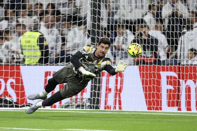 Real Madrid's Belgian goalkeeper #01 Thibaut Courtois warms up before the start of the Spanish league football match between Real Madrid CF and RC Celta de Vigo at the Santiago Bernabeu Stadium in Madrid on December 7, 2025.  Thomas COEX / AFP