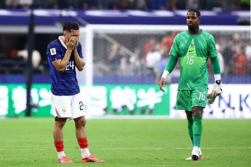 France's forward #24 Rayan Cherki and goalkeeper #16 Mike Maignan react after losing the 2026 World Cup football tournament semi-final match between France and Spain at the Dallas Stadium in Arlington on July 14, 2026.   CHARLY TRIBALLEAU / AFP