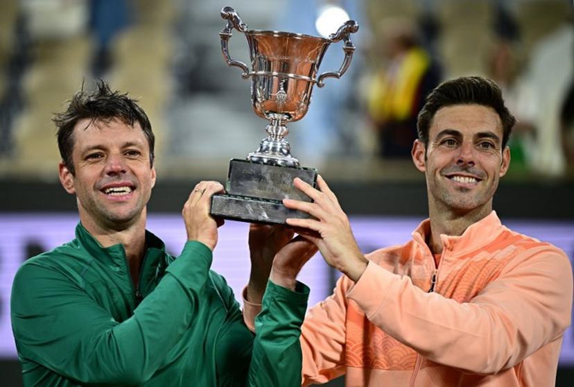 Argentina's Horacio Zeballos (L) and Spain's Marcel Granollers hold their trophy after winning their men's doubles final match against Britain's Joe Salisbury and Britain's Neal Skupski on day 14 of the French Open tennis tournament on Court Philippe-Chatrier at the Roland-Garros Complex in Paris on June 7, 2025.  JULIEN DE ROSA / AFP