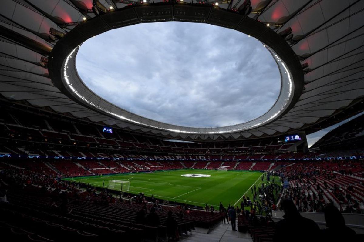 Supporters arrive before the start of the UEFA Champions League quarter final second leg football match between Club Atletico de Madrid and Manchester City FC at the Wanda Metropolitano stadium in Madrid on April 13, 2022.   OSCAR DEL POZO / AFP