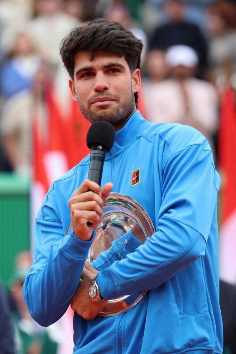 Spain's Carlos Alcaraz delivers a speech as he celebrates second place on the podium after the Monte Carlo ATP Masters Series Tournament final tennis match against Italy's Jannik Sinner on Court Rainier III at the Monte-Carlo Country Club in Roquebrune-Cap-Martin, south-eastern France on April 12, 2026.  Valery HACHE / AFP