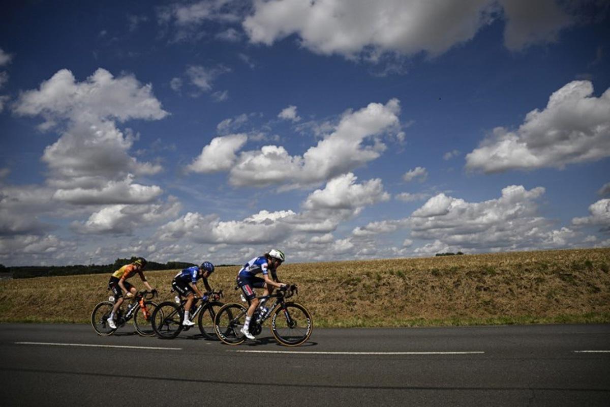 AG Insurance - Soudal Team's Belgian rider Julie Van De Velde, Team Visma | Lease a Bike's Dutch rider Femke de Vries and Team Visma | Lease a Bike's Dutch rider Fem van Empel cycle in a breakaway during the 5th stage (out of 8) of the third edition of the Women's Tour de France cycling race, a 152.5 km between Bastogne in southeastern Belgium and Amneville in northeastern France, on August 15, 2024.  JULIEN DE ROSA / AFP