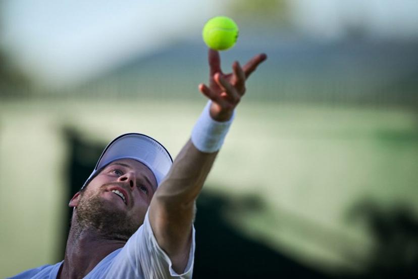 Netherlands' Botic Van De Zandschulp serves the ball to Italy's Matteo Arnaldi during their men's singles first round tennis match on the first day of the 2025 Wimbledon Championships at The All England Lawn Tennis and Croquet Club in Wimbledon, southwest London, on June 30, 2025.  Kirill KUDRYAVTSEV / AFP