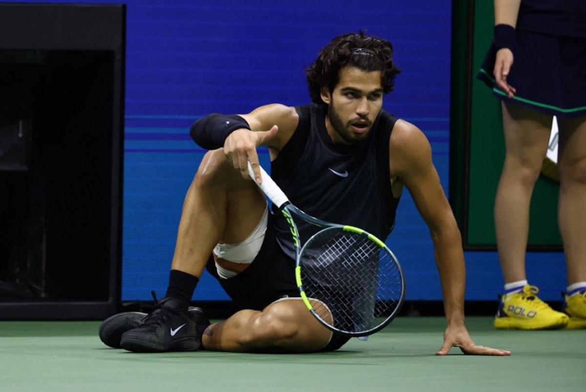 Spain's Carlos Alcaraz recovers after falling during the men's singles quarter-final tennis match against USA's Ben Shelton on day ten of the US Open tennis tournament at the USTA Billie Jean King National Tennis Center in New York City on September 9, 2026.  Leonardo MUNOZ / AFP