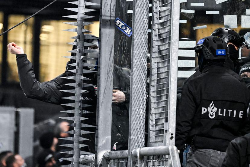 A masked Genk supporter provokes Dutch police ahead of a soccer game between Dutch soccer club FC Utrecht and Belgian KRC Genk, on Thursday 22 January 2026 in Utrecht, Netherlands, the seventh game (out of 8) in the league phase of the UEFA Europa League competition. BELGA PHOTO TOM GOYVAERTS