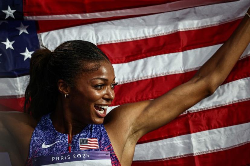 US' Gabrielle Thomas celebrates winning the women's 200m final of the athletics event at the Paris 2024 Olympic Games at Stade de France in Saint-Denis, north of Paris, on August 6, 2024.  Anne-Christine POUJOULAT / AFP