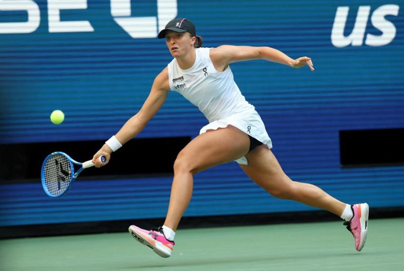 Poland's Iga Swiatek plays a shot to USA's Amanda Anisimova during their women's singles quarterfinal tennis match on day eleven of the US Open tennis tournament at the USTA Billie Jean King National Tennis Center in New York City on September 3, 2025.  TIMOTHY A. CLARY / AFP
