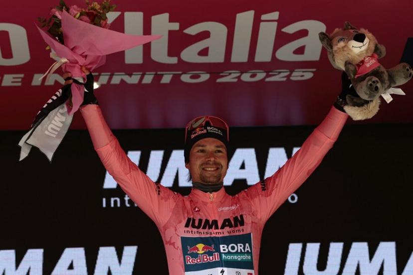 Red Bull-Bora-Hansgrohe's Slovenian rider Primoz Roglic celebrates the Pink jersey of the overall leader on the podium after the 7th stage of the 108th Giro d'Italia cycling race 168kms from Castel di Sangro to Tagliacozzo on May 16, 2025.  Luca Bettini / AFP