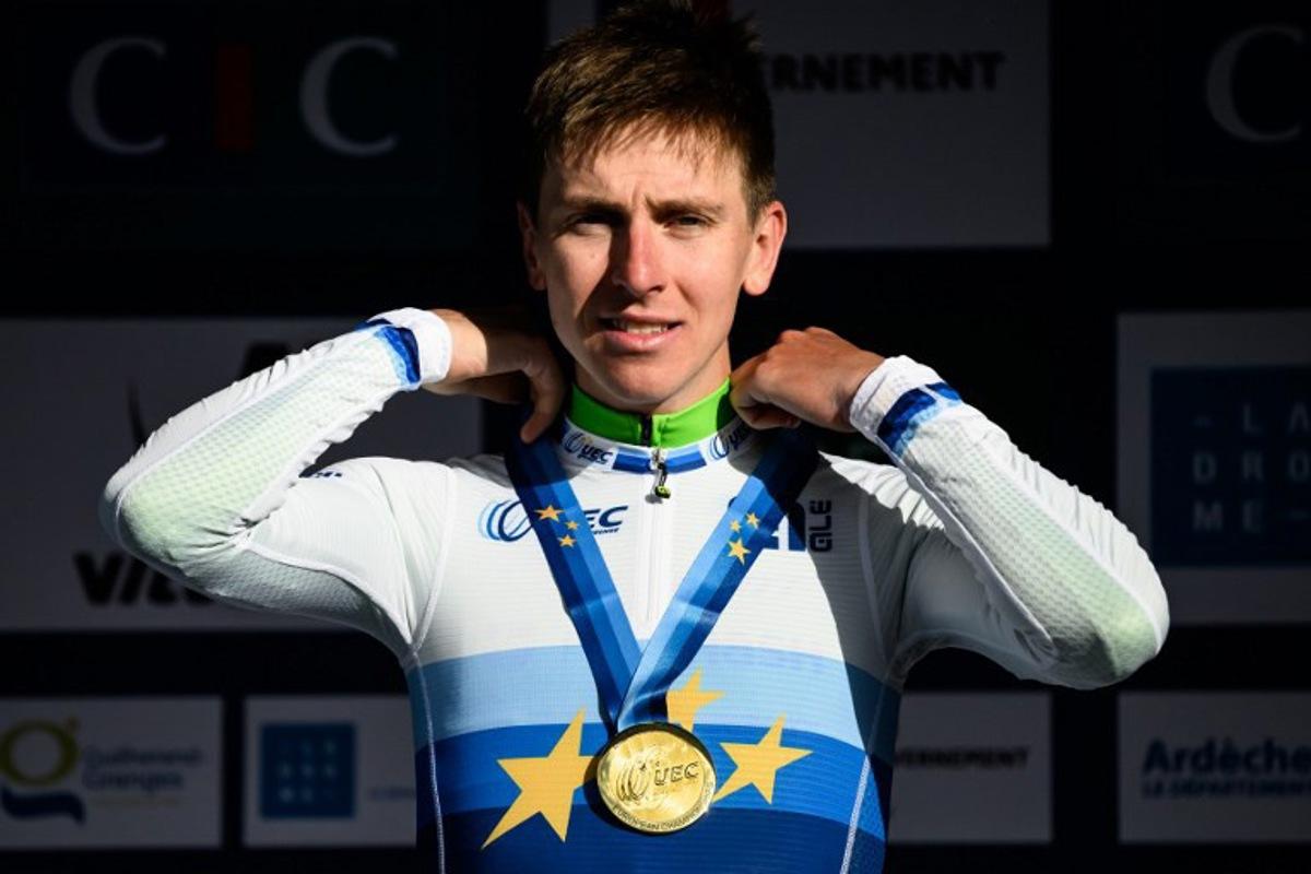 Slovenian rider Tadej Pogacar celebrates in the podium after winning the men's Elite Road Race at the European Cycling Championship 2025 near Valence, southeastern France on October 5, 2025.  JEFF PACHOUD / AFP