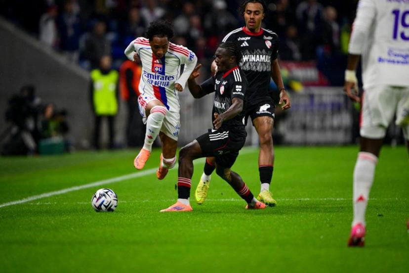 Lyon's Belgium forward #11 Malick Fofana fights for the ball with Strasbourg's Ivorian midfielder #42 Abdoul Ouattara during the French L1 football match between Olympique Lyonnais (OL) and RC Strasbourg Alsace at the Parc Olympique Lyonnais stadium in Decines-Charpieu, central-eastern France, on October 26, 2025.  OLIVIER CHASSIGNOLE / AFP