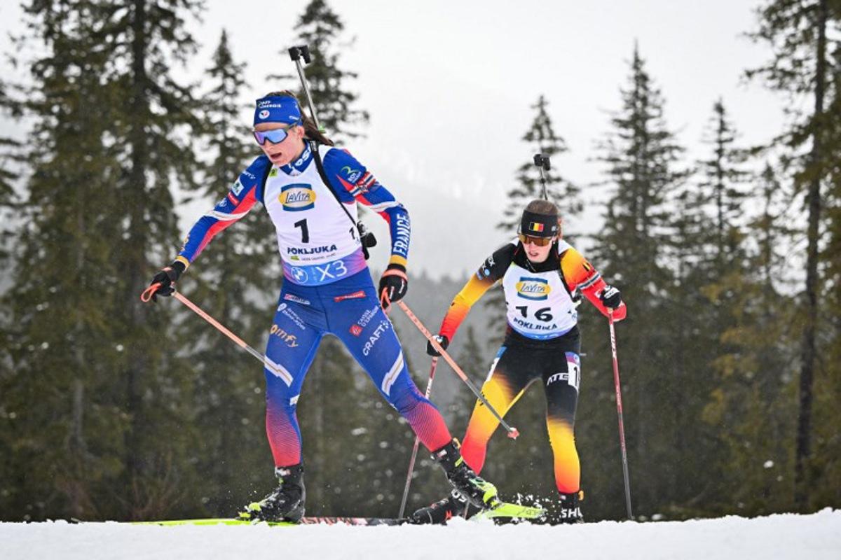 France's Justine Braisaz-Bouchet (L) and Belgium's Eve Bouvard compete during the Women 12.5 km Short Individual competition of the IBU Biathlon World Cup in Pokljuka, Slovenia on March 13, 2025.  Jure Makovec / AFP