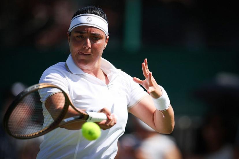 Tunisia's Ons Jabeur plays a forehand return to Bulgaria's Viktoriya Tomova during their women's singles first round tennis match on the first day of the 2025 Wimbledon Championships at The All England Lawn Tennis and Croquet Club in Wimbledon, southwest London, on June 30, 2025.  HENRY NICHOLLS / AFP