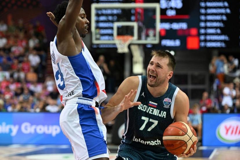 France's forward #34 Jaylen Hoard (L) and Slovenia's guard #77 Luka Doncic (R) vie during the FIBA EuroBasket 2025 Group D basketball match between France and Slovenia at the Spodek Arena in Katowice, Poland on August 30, 2025.  Sergei GAPON / AFP