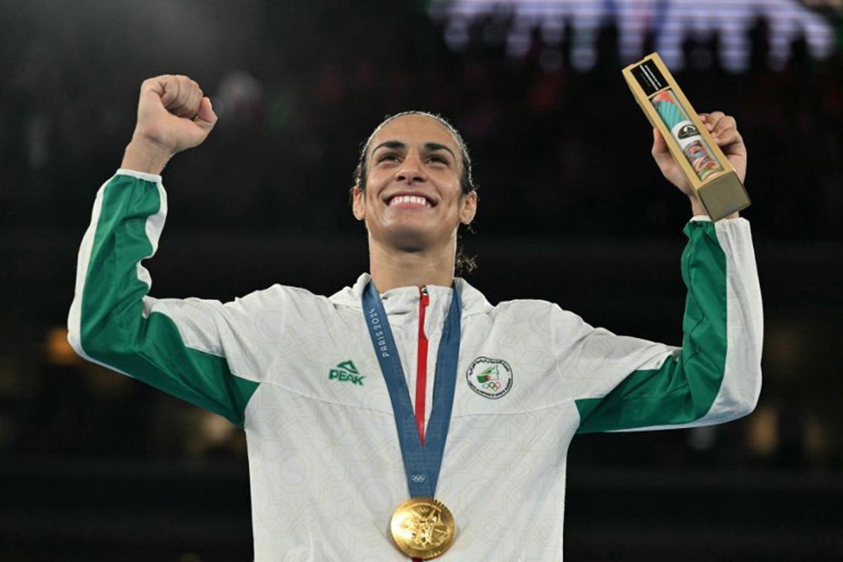 Gold medallist Algeria's Imane Khelif poses on the podium during the medal ceremony for the women's 66kg final boxing category during the Paris 2024 Olympic Games at the Roland-Garros Stadium, in Paris on August 9, 2024.  MOHD RASFAN / AFP