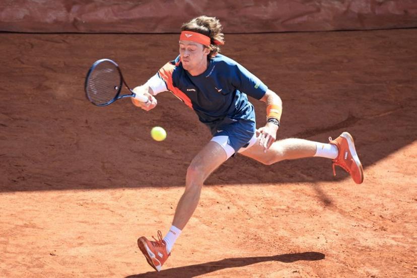 Russia's Andrey Rublev stretches to play a forehand return to France's Arthur Fils during the Monte Carlo ATP Masters Series Tournament round of 16 tennis match on the Court des Princes at the Monte Carlo Country Club in Roquebrune-Cap-Martin on April 10, 2025.  Valery HACHE / AFP