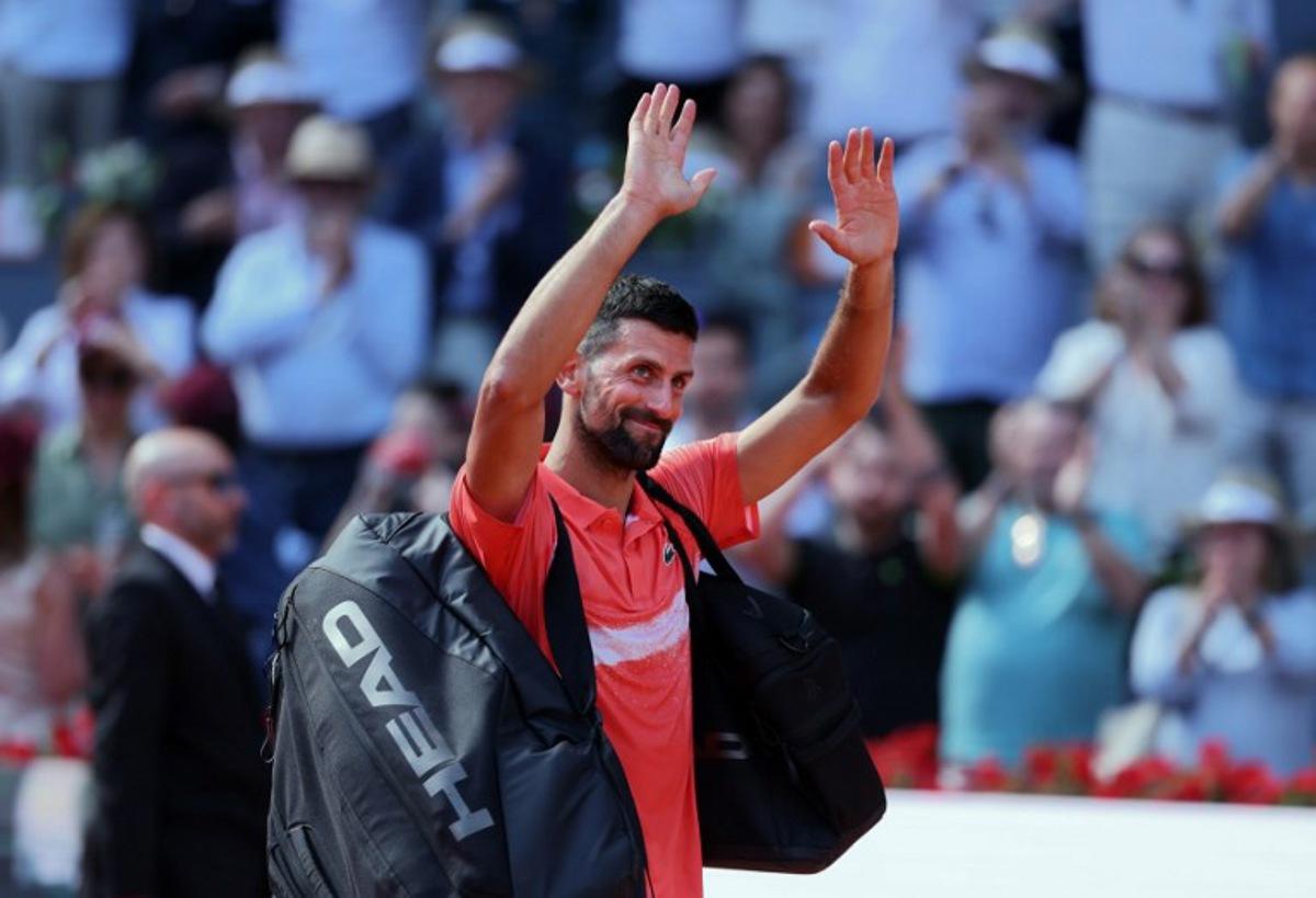 Serbia's Novak Djokovic waves after losing against Italy's Matteo Arnaldi  at the end of their 2025 ATP Tour Madrid Open tennis tournament second round singles match at the Caja Magica in Madrid, on April 26, 2025.  Thomas COEX / AFP
