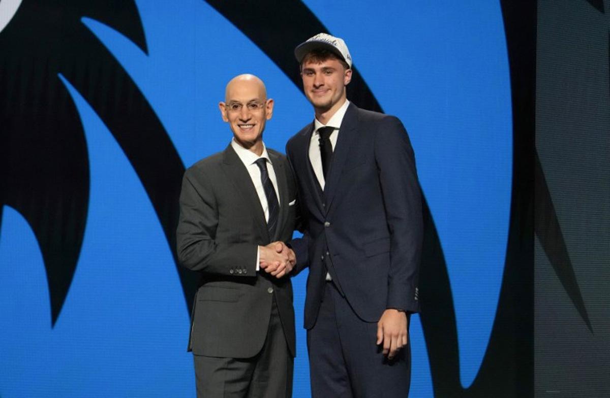 US basketball player Cooper Flagg (R) shakes hands with NBA Commissioner Adam Silver after being selected first overall by the Dallas Mavericks during the opening round of the 2025 NBA Draft at Barclays Center in Brooklyn, New York, on June 25, 2025. Versatile US college teen star Cooper Flagg was selected first overall in the NBA draft on June 25 by the Dallas Mavericks, where he'll join a star-laden team already touted as a playoff threat next season. Flagg, a consensus pick as the top US college player as a freshman at Duke University last season, is the second-youngest player taken first overall.  TIMOTHY A. CLARY / AFP