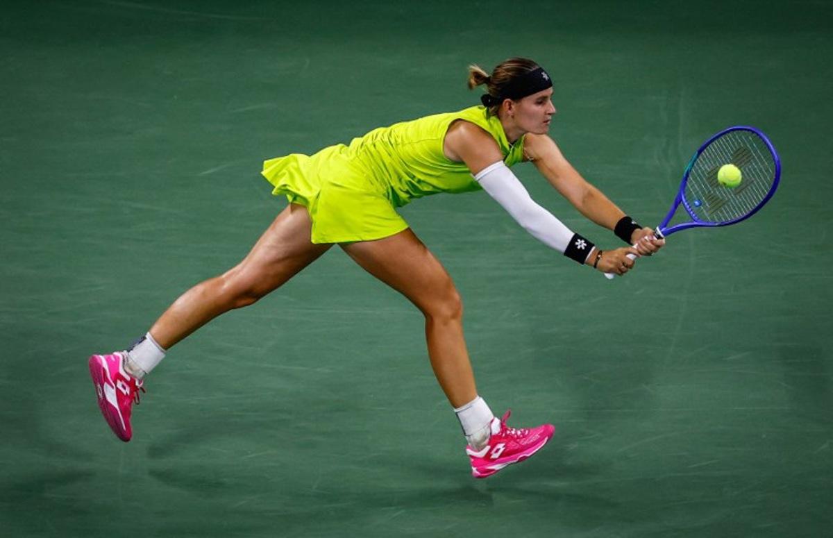 Belgium's Greet Minnen returns the ball to Japan's Naomi Osaka during their women's singles first round tennis match on day three of the US Open tennis tournament at the USTA Billie Jean King National Tennis Center in New York City, on August 26, 2025.  Kena Betancur / AFP