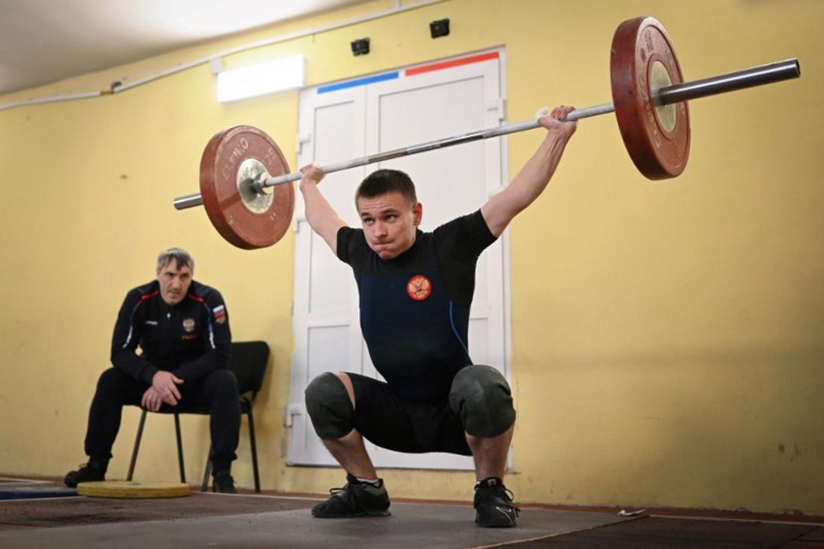 Russian weightlifter Oleg Musokhranov, 28, warms up before competing in his under 61kg category at the Russia Cup in Tula on January 28, 2024.  Natalia KOLESNIKOVA / AFP