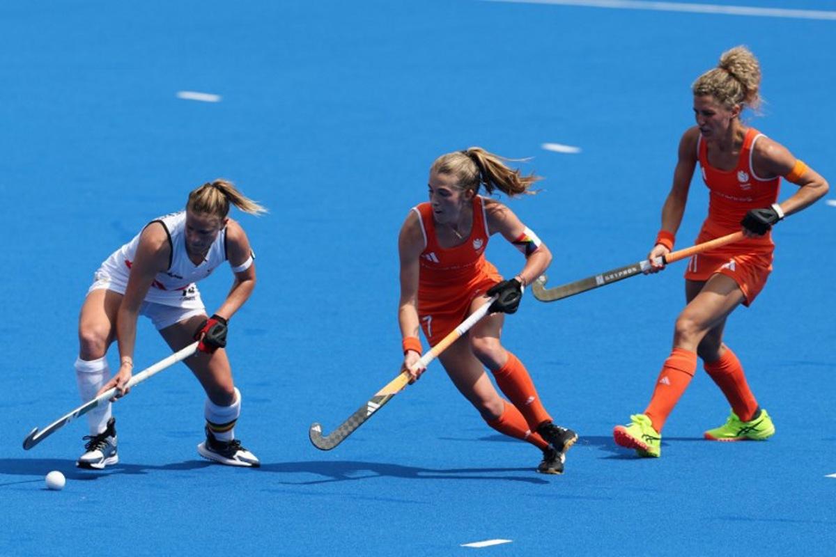 Belgium's midfielder #40 Camille Belis is marked by Netherlands' midfielder #07 Xan De Waard in the women's pool A field hockey match between Belgium and the Netherlands during the Paris 2024 Olympic Games at the Yves-du-Manoir Stadium in Colombes on August 2, 2024.  Ahmad GHARABLI / AFP