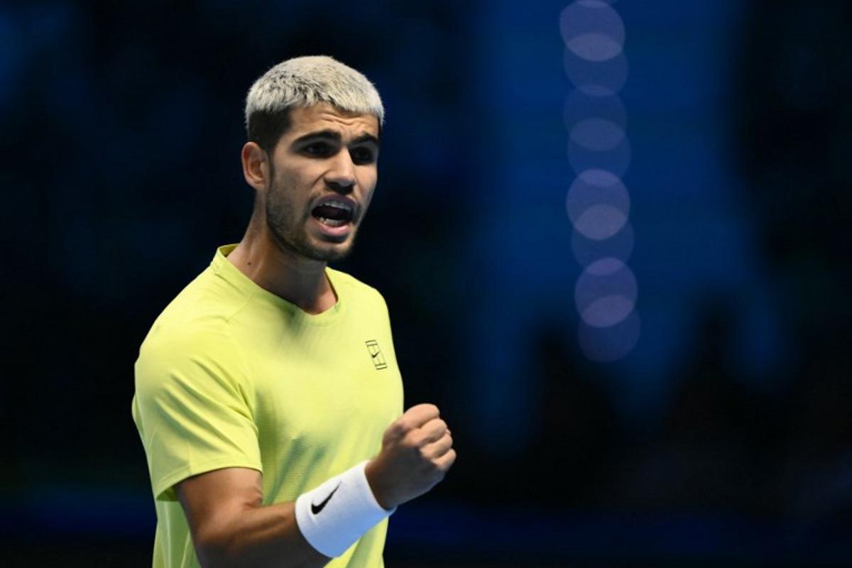 Spain's Carlos Alcaraz reacts during his semifinal match against Canada's Felix Auger-Aliassime at the ATP Finals tennis tournament in Turin on November 15, 2025.  Marco BERTORELLO / AFP