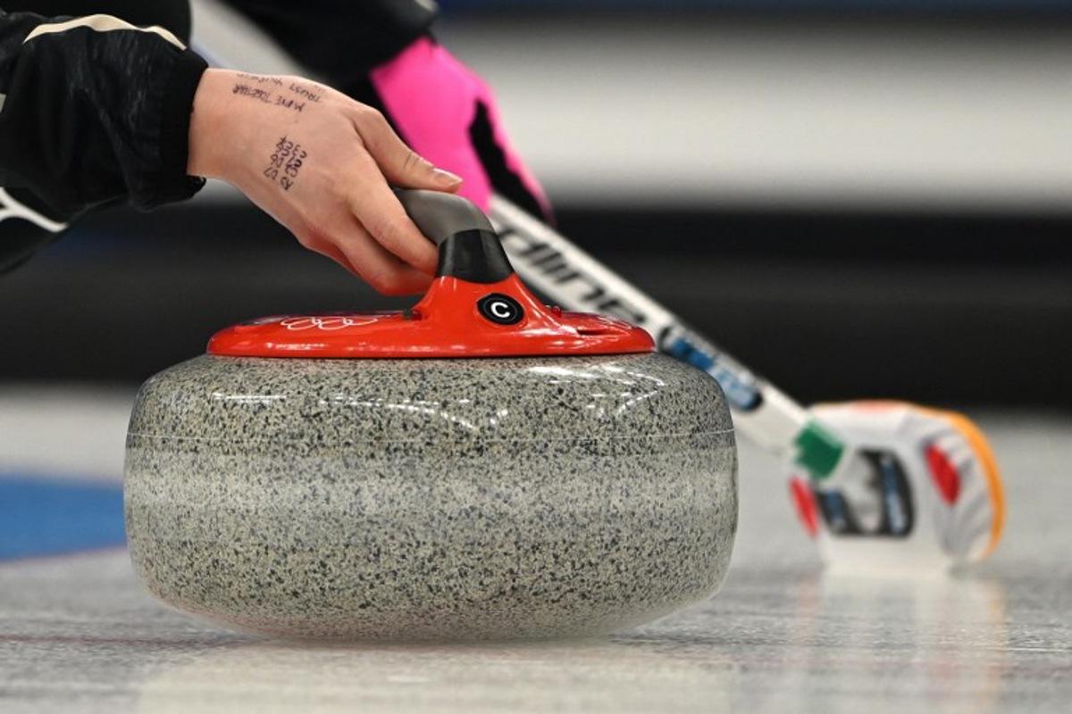 Japan's Satsuki Fujisawa curls the stone during the women's gold medal game of the Beijing 2022 Winter Olympic Games curling competition between Japan and Great Britain at the National Aquatics Centre in Beijing on February 20, 2022.  Lillian SUWANRUMPHA / AFP