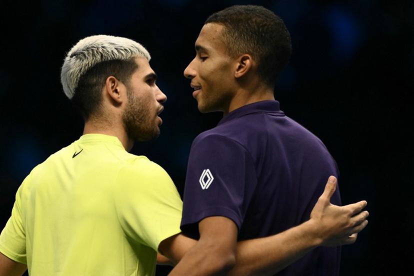 Spain's Carlos Alcaraz is congratulated by Canada's Felix Auger-Aliassime after winning the semifinal at the ATP Finals tennis tournament in Turin on November 15, 2025.  Marco BERTORELLO / AFP