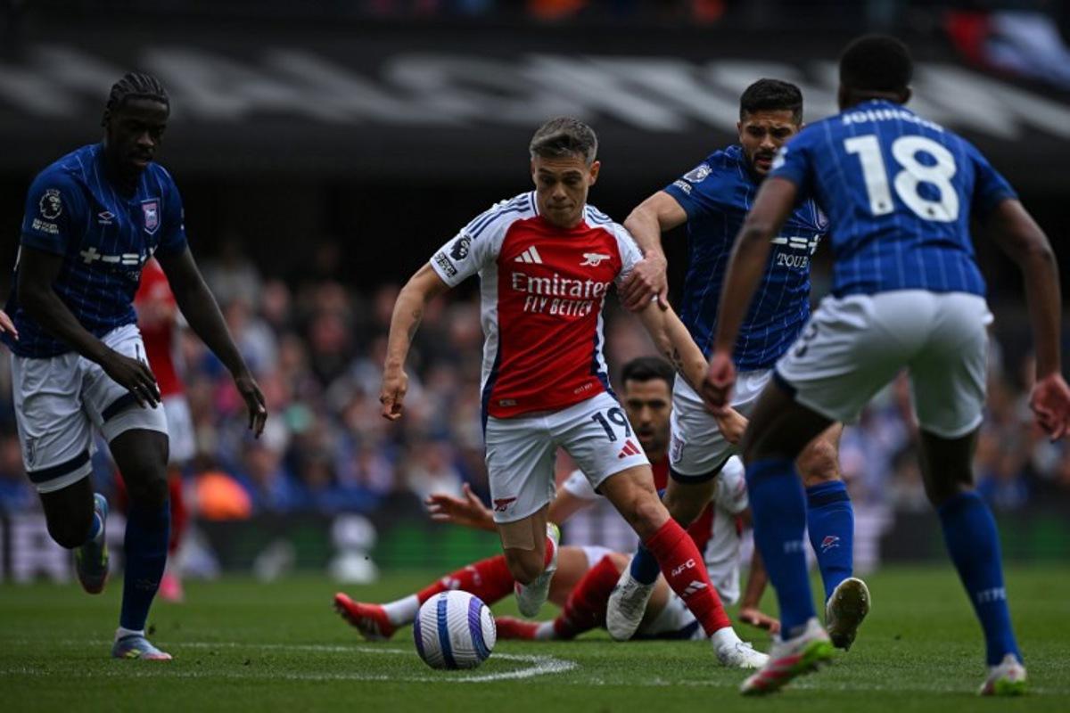 Arsenal's Belgian midfielder #19 Leandro Trossard (C) runs with the ball during the English Premier League football match between Ipswich Town and Arsenal at Portman Road in Ipswich, eastern England on April 20, 2025.  Ben STANSALL / AFP