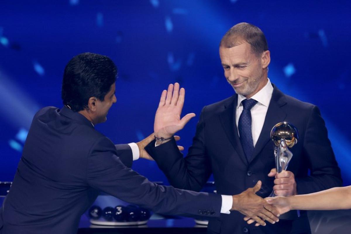 Paris Saint Germain's Qatari president Nasser al-Khelaifi (L) receives UEFA Respect Award from UEFA President Aleksander Ceferin during the draw ceremony for the league phase of the 2026-2027 UEFA Champions League football tournament at the Grimaldi Forum in the Principality of Monaco on August 27, 2026.  Valery HACHE / AFP