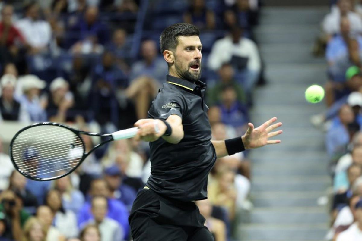 Serbia's Novak Djokovic hits a forehand return to Britain's Cameron Norrie during their men's singles third round match on day six of the US Open tennis tournament at the USTA Billie Jean King National Tennis Center in New York City on August 29, 2025.  CHARLY TRIBALLEAU / AFP
