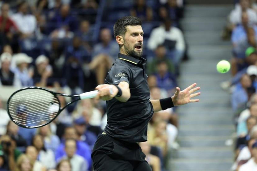 Serbia's Novak Djokovic hits a forehand return to Britain's Cameron Norrie during their men's singles third round match on day six of the US Open tennis tournament at the USTA Billie Jean King National Tennis Center in New York City on August 29, 2025.  CHARLY TRIBALLEAU / AFP