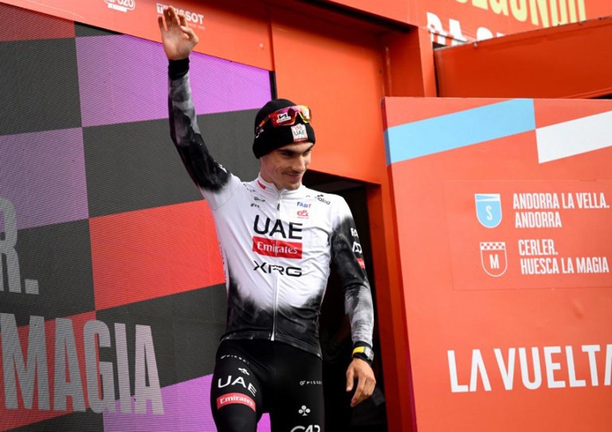 Team UAE's Spanish rider Juan Ayuso celebrates on the podium after winning the seventh stage of the Vuelta a Espana, a 187 km race between Andorra la Vella and Cerler, on August 29, 2025.    Josep LAGO / AFP