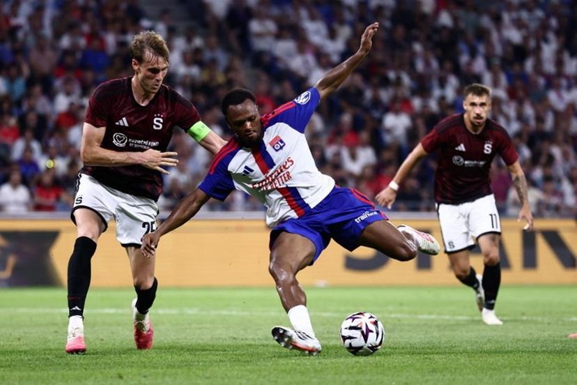 Sparta Praha's Danish defender #25 Asger Sorensen (L) and Lyon's Belgian forward #17 Lois Openda (C) fight for the ball during the UEFA Champions League third qualifying round - second leg football match between Olympique Lyonnais (OL) and Sparta Prague at Groupama Stadium in Decines-Charpieu, central-eastern France on August 11, 2026.  Alex MARTIN / AFP