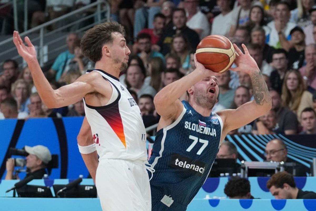 Germany's guard #09 Franz Wagner and Slovenia's guard #77 Luka Doncic vie for the ball during the FIBA EuroBasket 2025 quarter-final basketball match between Germany and Slovenia in Riga, Latvia, on September 10, 2025.  Gints Ivuskans / AFP