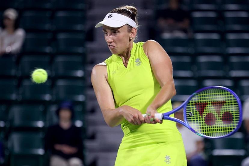 Belgium's Elise Mertens hits a return to Spain's Cristina Busca during their women's singles match at the Japan Open tennis tournament in Osaka on October 14, 2025.  PAUL MILLER / AFP