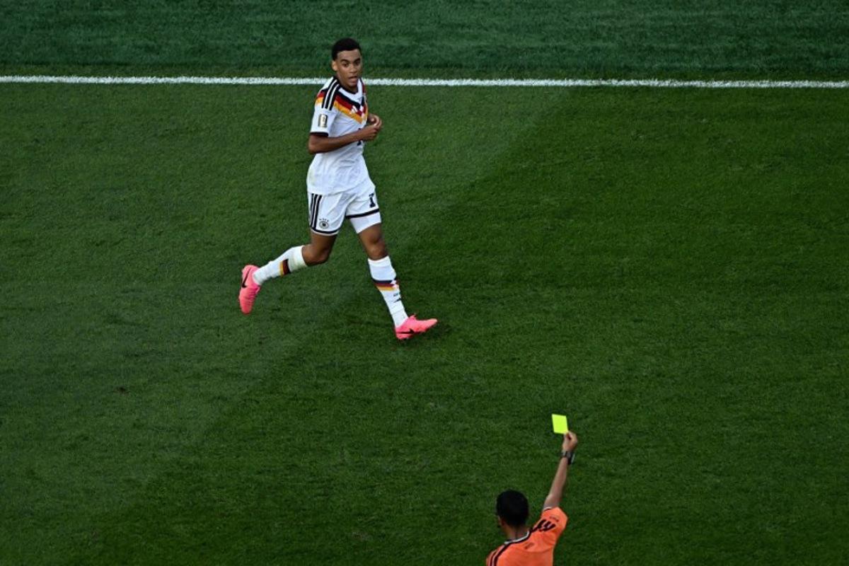 Moroccan referee Jalal Jayed shows a yellow card to Germany's midfielder #10 Jamal Musiala during the 2026 World Cup round of 32 football match between Germany and Paraguay at the Boston Stadium in Foxborough on June 29, 2026.   Jewel SAMAD / AFP