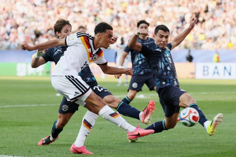 Germany's midfielder #10 Jamal Musiala kicks the ball past Paraguay's midfielder #23 Matias Galarza and defender #06 Junior Alonso during the 2026 World Cup round of 32 football match between Germany and Paraguay at the Boston Stadium in Foxborough on June 29, 2026.   Odd ANDERSEN / AFP