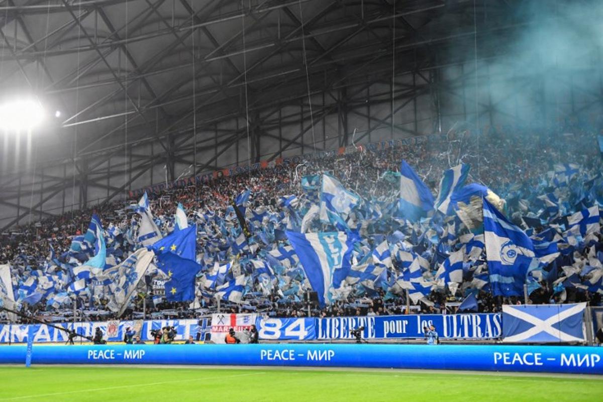 Marseille's supporters wave flags during the UEFA Europa League quarter final second leg football match between Olympique de Marseille (OM) and SL Benfica at the Stade Velodrome in Marseille on April 18, 2024.  Sylvain THOMAS / AFP