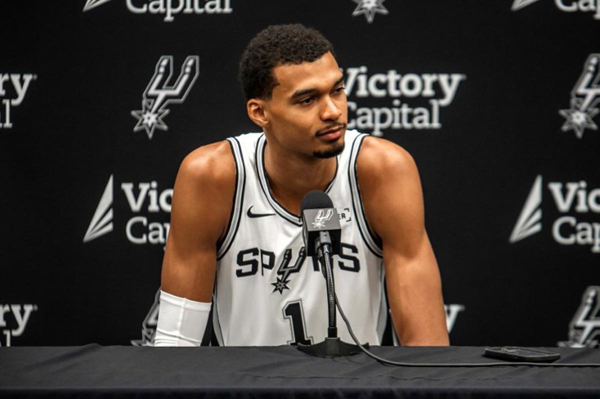 French basketball player Victor Wembanyama speaks to reporters during the San Antonio Spurs media day at the Victory Capital Performance Center in San Antonio, Texas on September 29, 2025. Wembanyama has been cleared by the team's medical staff to play for the upcoming season. SERGIO FLORES / AFP