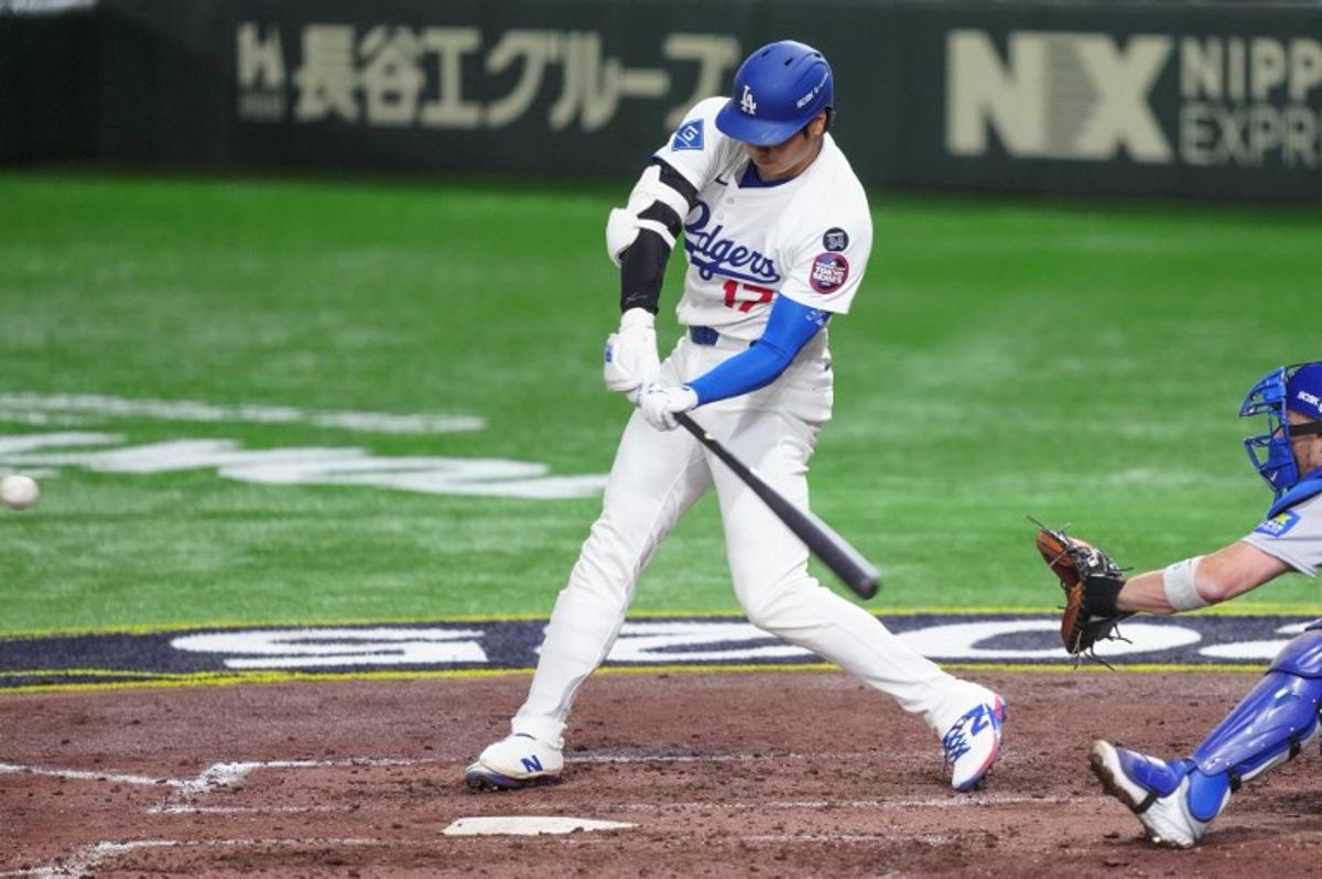 Los Angeles Dodgers's Shohei Ohtani hits a home-run in the fifth inning during the baseball game between Los Angeles Dodgers and Chicago Cubs in the MLB Tokyo Series at the Tokyo Dome in Tokyo on March 19, 2025.  Yuichi YAMAZAKI / AFP