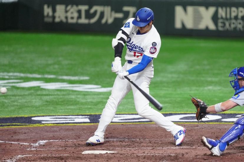 Los Angeles Dodgers's Shohei Ohtani hits a home-run in the fifth inning during the baseball game between Los Angeles Dodgers and Chicago Cubs in the MLB Tokyo Series at the Tokyo Dome in Tokyo on March 19, 2025.  Yuichi YAMAZAKI / AFP