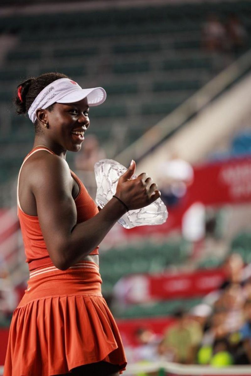 Victoria Mboko of Canada holds the trophy after winning against Cristina Bucsa of Spain in the women's singles final of the Hong Kong Tennis Open in Hong Kong on November 2, 2025.  May JAMES / AFP