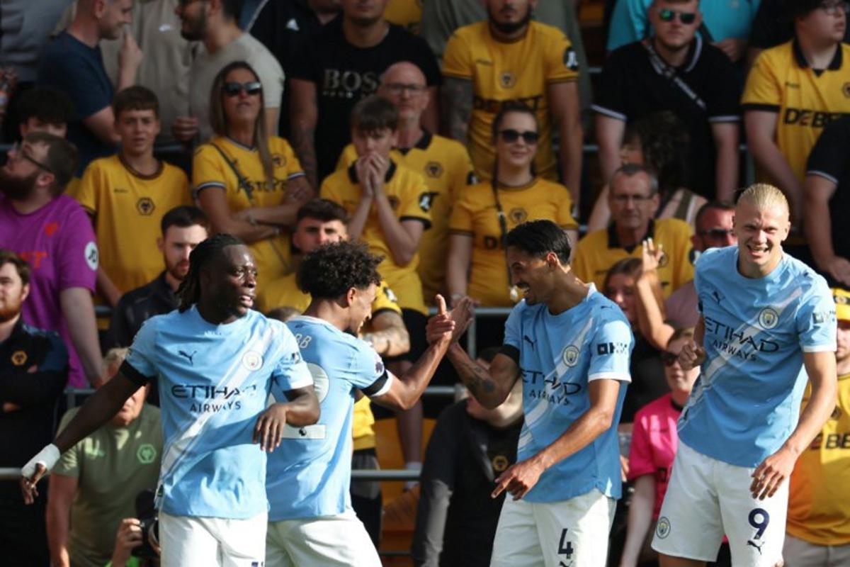 Manchester City's Dutch midfielder #04 Tijjani Reijnders (2R) celebrates scoring their second goal with Manchester City's Belgian midfielder #11 Jeremy Doku (L), Manchester City's Norwegian midfielder #52 Oscar Bobb (2L) and Manchester City's Norwegian striker #09 Erling Haaland (R) during the English Premier League football match between Wolverhampton Wanderers and Manchester City at the Molineux stadium in Wolverhampton, central England on August 16, 2025.  Darren Staples / AFP