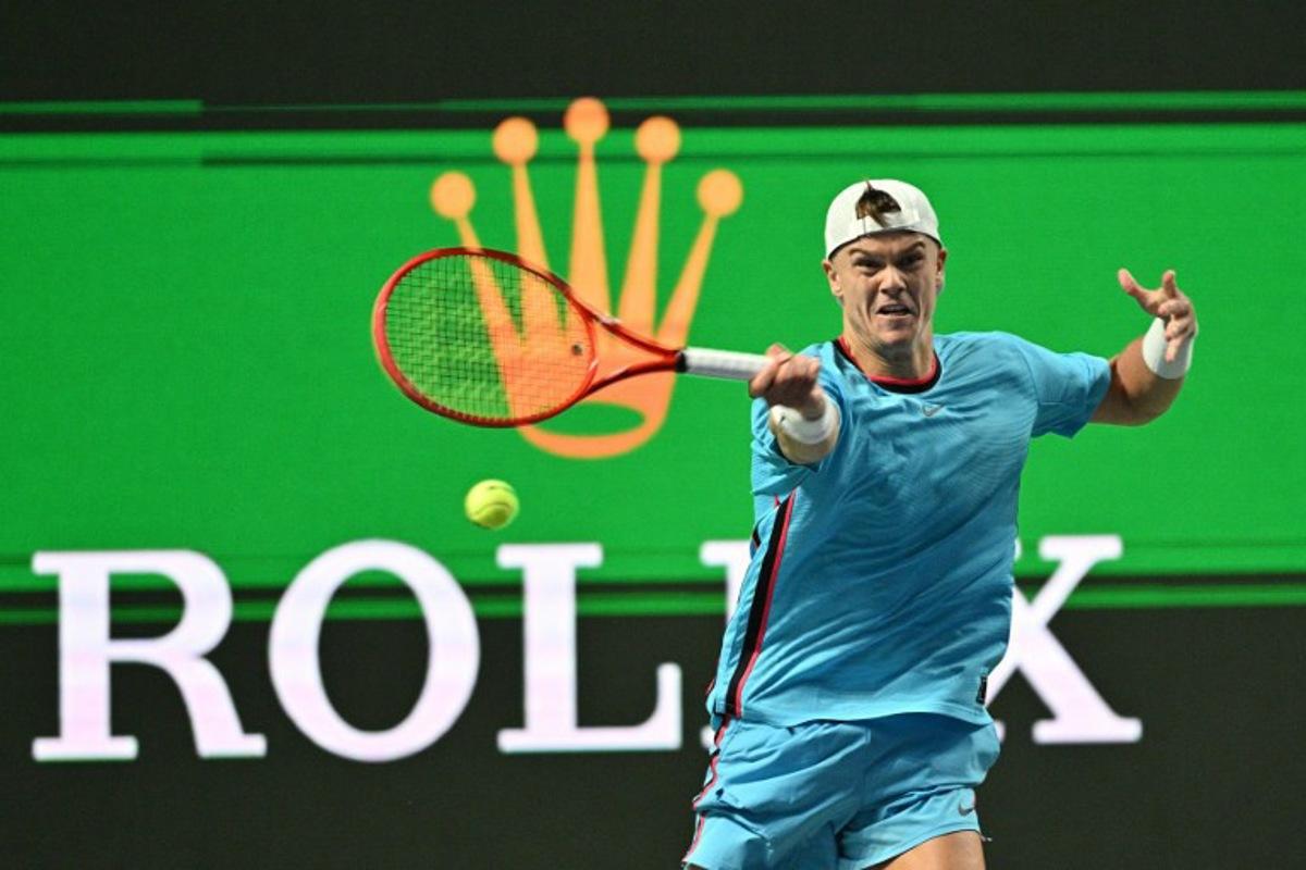 Denmark's Holger Rune hits a return to Germany's Daniel Altmaier during their men's singles match at the Shanghai Masters tennis tournament in Shanghai on October 7, 2026.  Hector RETAMAL / AFP