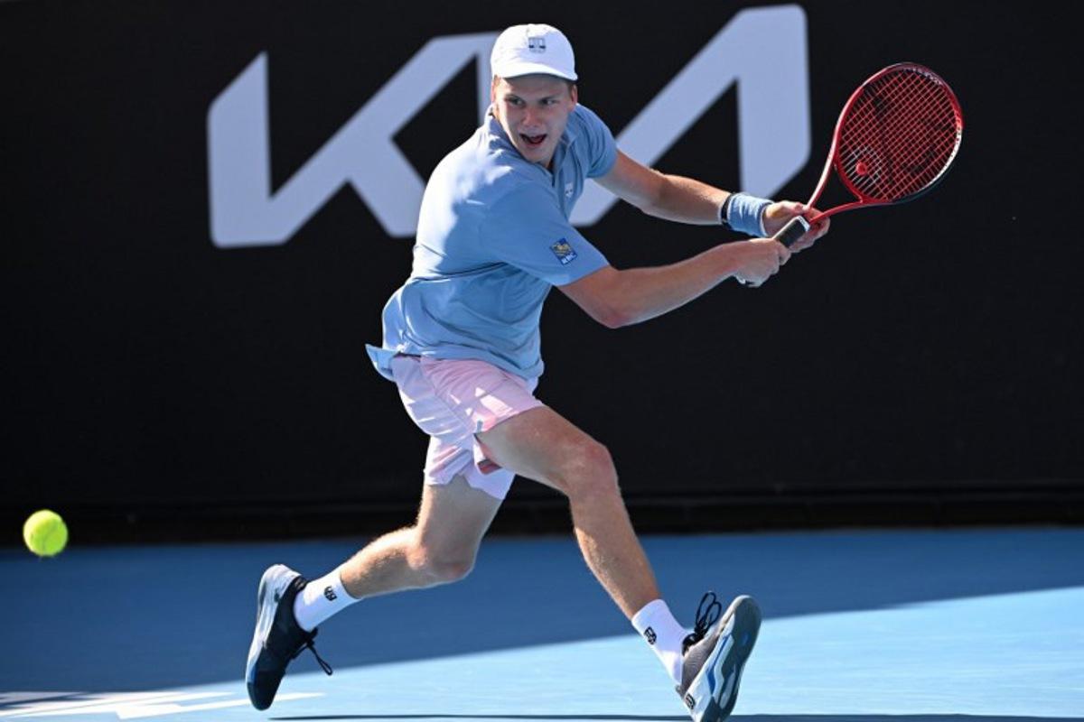 USA's Jenson Brooksby hits a return against USA's Tommy Paul during their men's singles match on day six of the Australian Open tennis tournament in Melbourne on January 21, 2023. WILLIAM WEST / AFP
