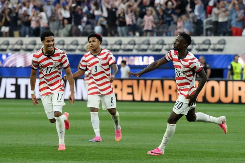 US forward #20 Folarin Balogun (R) celebrates scoring his team's third goal during the 2026 World Cup Group D football match between USA and Paraguay at the Los Angeles Stadium in Inglewood on June 12, 2026.  Patrick T. Fallon / AFP