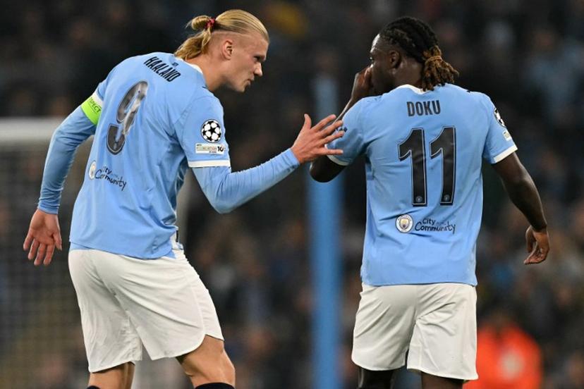 Manchester City's Norwegian striker #09 Erling Haaland (L) celebrates scoring his team's second goal with Manchester City's Belgian midfielder #11 Jeremy Doku during the UEFA Champions League football match between Manchester City and Borussia Dortmund at the Etihad Stadium in Manchester, north west England, on November 5, 2025.  Oli SCARFF / AFP