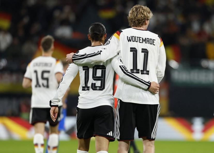 Germany's midfielder #19 Leroy Sane (L) celebrates with Germany's forward #11 Nick Woltemade scoring his team's third goal during the FIFA World Cup 2026 European qualification Group A football match between Germany and Slovakia, at the Red Bull Arena in Leipzig, eastern Germany on November 17, 2025.  Odd ANDERSEN / AFP