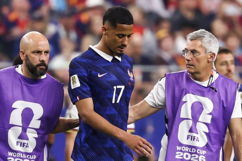 France's defender #17 William Saliba leaves the pitch after an injury during the 2026 World Cup football tournament semi-final match between France and Spain at the Dallas Stadium in Arlington on July 14, 2026.   FRANCK FIFE / AFP